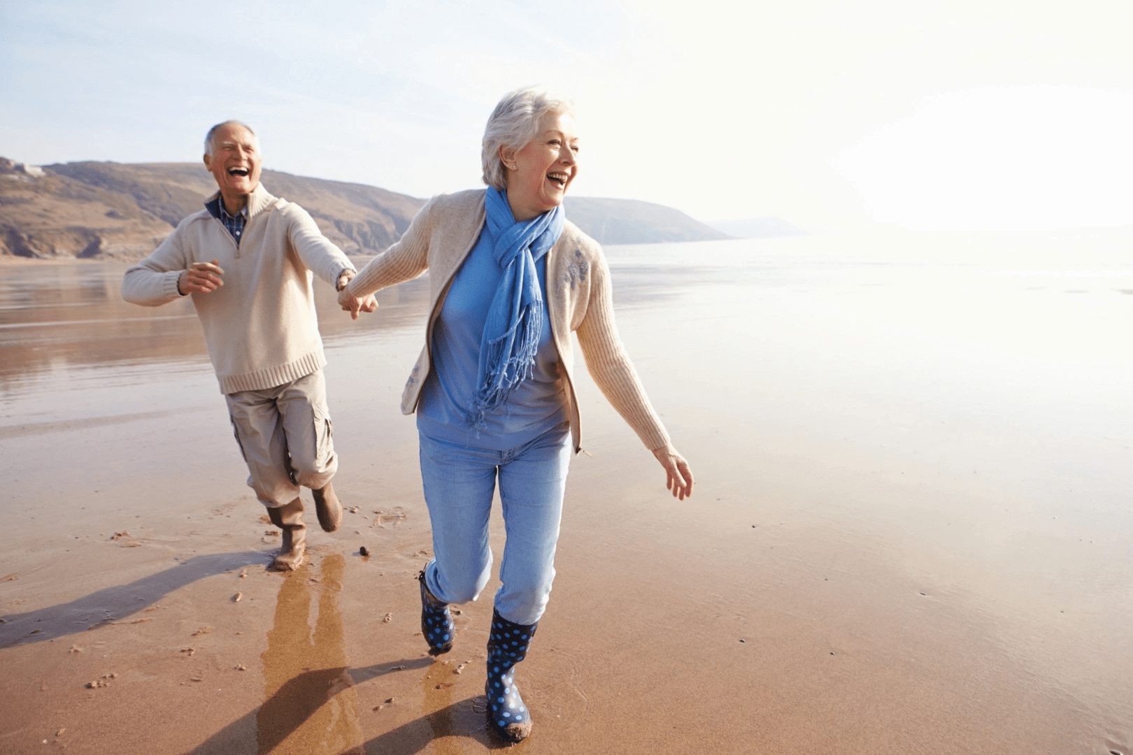 An old couple strolling on the beach